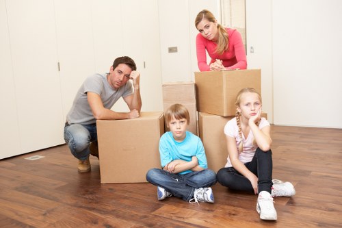 Professional movers handling office equipment